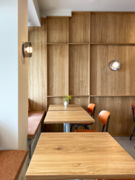 Interior of Bon'gu featuring an earthy palette, terracotta tiles, and wood panels for a comfortable yet elegant atmosphere.before matter interior design frankfurt. before matter, architecture & interior design studio Frankfurt am Main