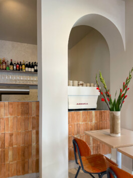 Interior of Bon'gu featuring an earthy palette, terracotta tiles, and wood panels for a comfortable yet elegant atmosphere.before matter interior design frankfurt. before matter, architecture & interior design studio Frankfurt am Main