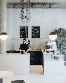 Barista bar at Drei Kaffeebar featuring a modern stainless steel modbar and reclaimed wood accents before matter, architecture & interior design studio Frankfurt am Main